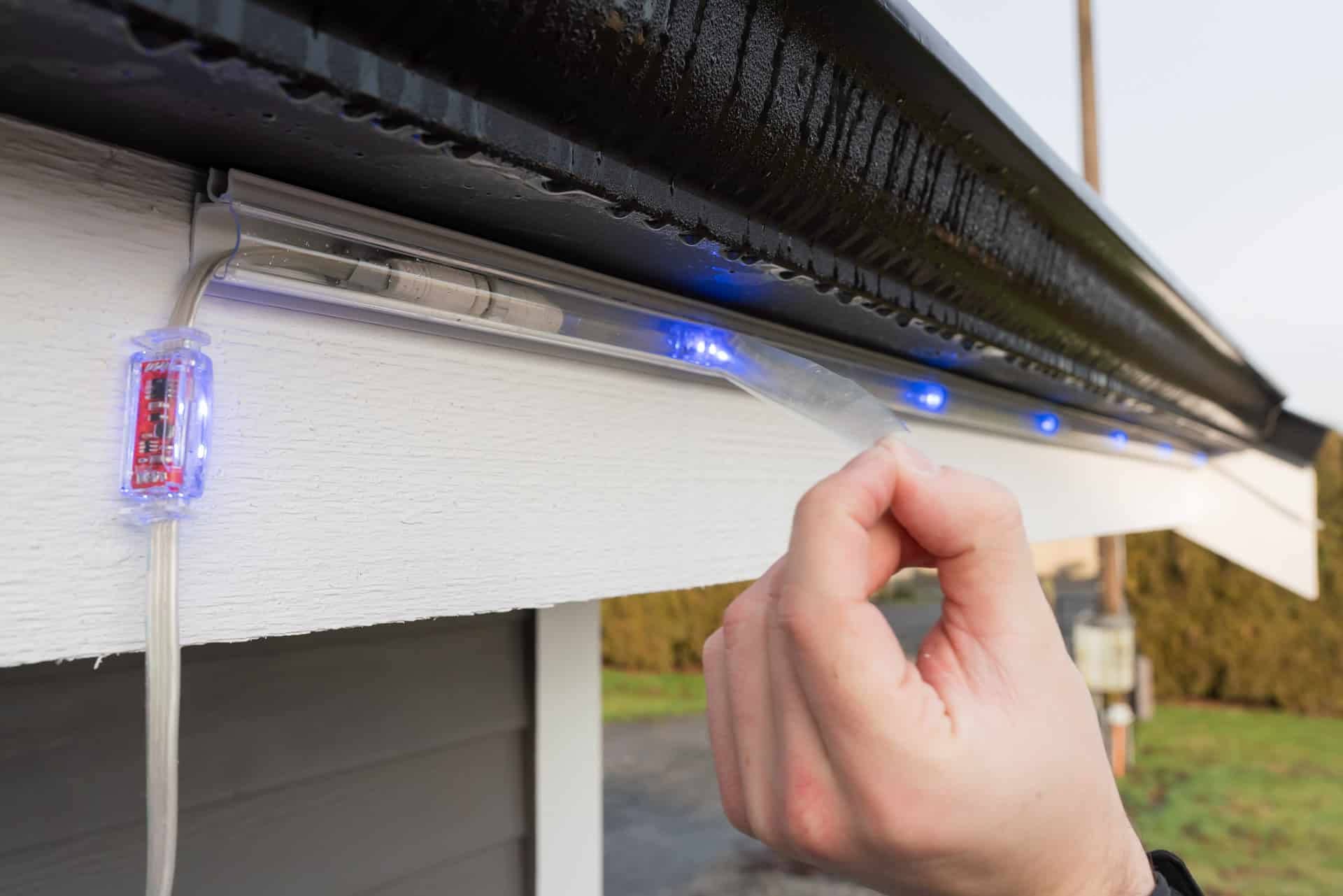 An installer shows how permanent outdoor lighting is weather-proofed