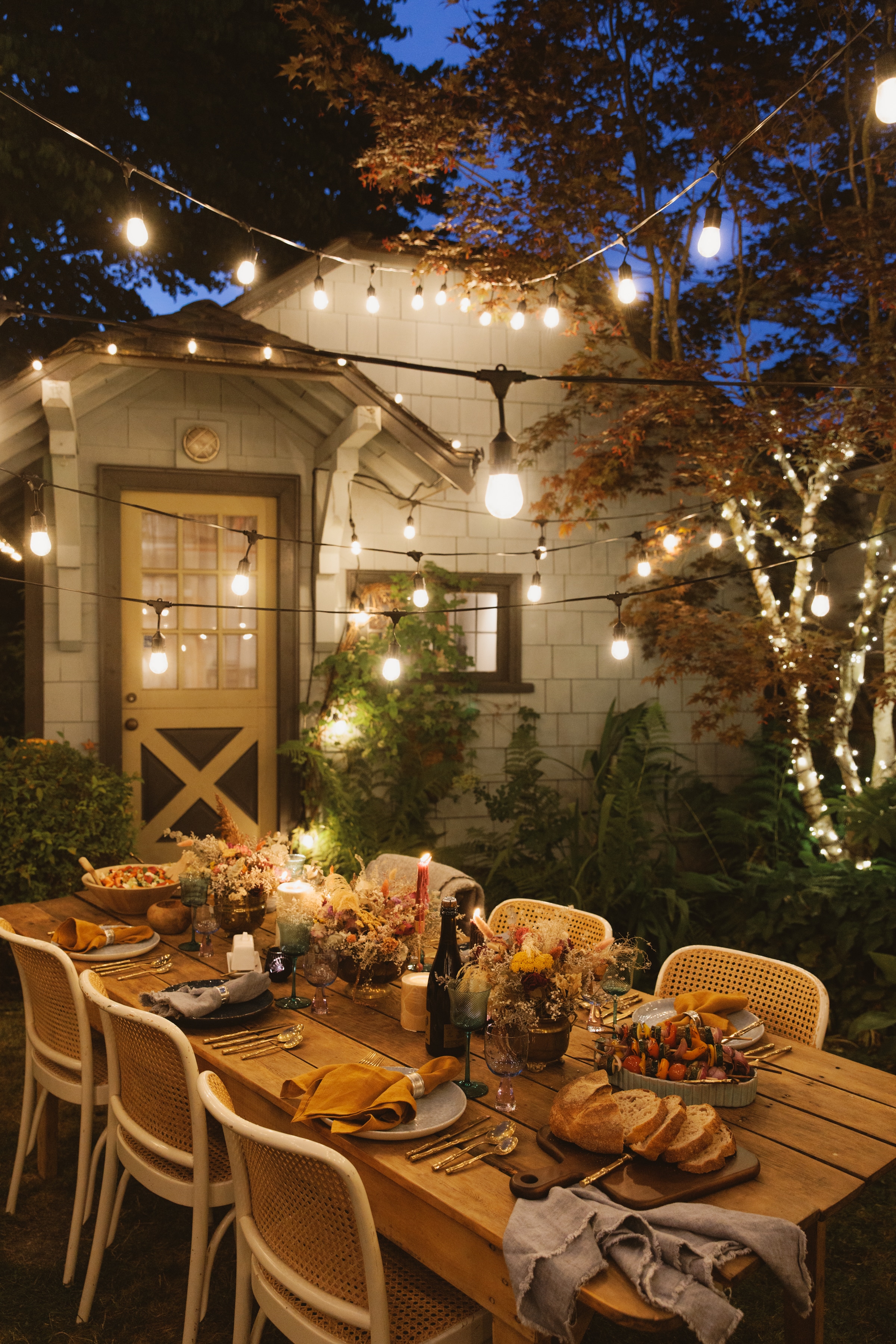Patio lighting above table with place settings and candles